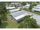 Overhead view highlighting roof, manicured lawns, mature trees, and community at 6710 36 E Ave # 114, Palmetto, FL 34221