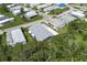 Drone shot showing home nestled among mature trees, manicured lawns, and community at 6710 36 E Ave # 114, Palmetto, FL 34221