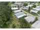Aerial view of the community featuring mature trees, community pool, and well maintained manufactured homes at 6710 36 E Ave # 114, Palmetto, FL 34221