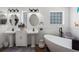 Bright bathroom featuring double sinks, modern fixtures, and a soaking tub at 6710 36 E Ave # 114, Palmetto, FL 34221