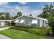 Exterior of the residence, showcasing well-maintained landscaping and a covered carport entrance at 6710 36 E Ave # 114, Palmetto, FL 34221