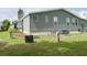 The exterior features metal siding, a stone foundation, and well-maintained landscaping at 6710 36 E Ave # 114, Palmetto, FL 34221