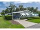 Charming single-story home featuring a covered carport, awnings, and lush, manicured landscaping at 6710 36 E Ave # 114, Palmetto, FL 34221