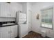 Functional laundry room with a stacked washer and dryer, with overhead cabinets at 6710 36 E Ave # 114, Palmetto, FL 34221