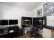View of home office space featuring built in desk, overhead storage, and hardwood flooring at 6710 36 E Ave # 114, Palmetto, FL 34221