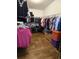 Spacious walk-in closet features ample hanging storage, shoe racks, and wood-look flooring at 6710 36 E Ave # 114, Palmetto, FL 34221