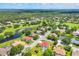 Aerial view of a residential neighborhood with golf course, ponds, and mature trees at 7133 Dornough Ln, Bradenton, FL 34202