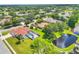 Aerial view of a residential neighborhood with single-Gathering homes and pond at 7133 Dornough Ln, Bradenton, FL 34202