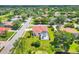 Aerial view of a single-Gathering home with pool, manicured lawn, and mature trees at 7133 Dornough Ln, Bradenton, FL 34202