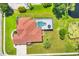 Aerial view of property with screened pool, pond, mature trees, and well-maintained landscaping at 7133 Dornough Ln, Bradenton, FL 34202