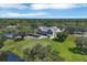 Aerial view of the clubhouse, golf course and lake, surrounded by lush trees and manicured lawns at 7133 Dornough Ln, Bradenton, FL 34202