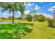 Lush backyard with pond and mature trees, ideal for outdoor enjoyment at 7133 Dornough Ln, Bradenton, FL 34202
