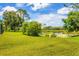 Beautiful backyard with a pond and greenery at 7133 Dornough Ln, Bradenton, FL 34202