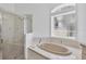 Bathroom features a soaking tub, a shower, and a window at 7133 Dornough Ln, Bradenton, FL 34202