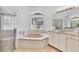 Bathroom with a shower, a soaking tub, and a large mirror at 7133 Dornough Ln, Bradenton, FL 34202