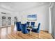 Elegant dining room with a glass table, plush blue chairs, and a view of the double-door entry at 7133 Dornough Ln, Bradenton, FL 34202