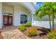 Inviting front entrance with a red door, brick walkway, and well-maintained landscaping at 7133 Dornough Ln, Bradenton, FL 34202