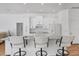 Bright kitchen features white cabinets, marble countertops, and seating at the breakfast bar at 7133 Dornough Ln, Bradenton, FL 34202