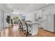 Open concept kitchen with white cabinets, marble countertops, and breakfast bar seating at 7133 Dornough Ln, Bradenton, FL 34202