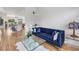 Living room with hardwood floors, bright light, blue velvet sofa, and open concept design at 7133 Dornough Ln, Bradenton, FL 34202
