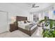 Relaxing main bedroom with tufted headboard, bright windows, and marble floors at 7133 Dornough Ln, Bradenton, FL 34202