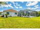 Enclosed pool and patio area, with lawn and sunny skies at 7133 Dornough Ln, Bradenton, FL 34202