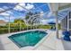 Screened pool with attached spa, blue trim, and two lounge chairs for relaxing poolside at 7133 Dornough Ln, Bradenton, FL 34202