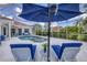Enclosed pool area with hot tub, lounge chairs, and ample space for entertaining at 7133 Dornough Ln, Bradenton, FL 34202