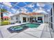 Enclosed pool area with hot tub, lounge chairs, and ample space for entertaining at 7133 Dornough Ln, Bradenton, FL 34202