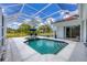 Enclosed pool area with hot tub, lounge chairs, and ample space for entertaining at 7133 Dornough Ln, Bradenton, FL 34202