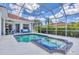 Inviting screened pool and spa with outdoor dining area and lush landscaping at 7133 Dornough Ln, Bradenton, FL 34202