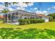 Enclosed pool area with lawn and mature landscaping at 7133 Dornough Ln, Bradenton, FL 34202