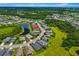 Neighborhood aerial view showcasing homes and landscaping in a lakefront community under a blue sky at 773 Rosemary Cir, Bradenton, FL 34212