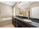 This bathroom features a dual sink vanity with granite countertop, a soaking tub, and a separate shower at 773 Rosemary Cir, Bradenton, FL 34212