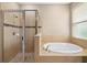 This bathroom features a glass-enclosed shower and a soaking tub by the window, creating a relaxing space at 773 Rosemary Cir, Bradenton, FL 34212