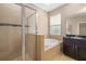 This bathroom features a glass-enclosed shower and a soaking tub by the window, creating a relaxing space at 773 Rosemary Cir, Bradenton, FL 34212