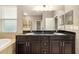 This bathroom features a dual sink vanity with granite countertop and a soaking tub with window views at 773 Rosemary Cir, Bradenton, FL 34212
