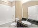This bathroom features a shower and tub combination, a toilet, and vanity with granite countertop at 773 Rosemary Cir, Bradenton, FL 34212