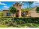 Charming home with a manicured lawn, landscaping, and inviting front door at 773 Rosemary Cir, Bradenton, FL 34212