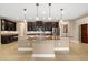 A kitchen features dark cabinets with granite countertops, an island, and stainless steel appliances at 773 Rosemary Cir, Bradenton, FL 34212