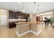 Spacious kitchen features dark cabinetry, granite countertops, an island, and stainless steel appliances at 773 Rosemary Cir, Bradenton, FL 34212