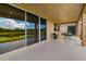 Spacious covered patio with sliding glass doors offering seamless indoor-outdoor living with pond view at 773 Rosemary Cir, Bradenton, FL 34212