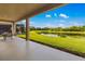 Covered patio overlooking the lush lawn and pond for outdoor relaxation and serene views at 773 Rosemary Cir, Bradenton, FL 34212
