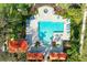 Aerial view of the community pool, showing the layout with seating, spa, and surrounding vegetation at 7750 Ridgelake Cir, Bradenton, FL 34203