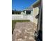 Paver patio area in backyard with a white fence and view of neighboring house at 7750 Ridgelake Cir, Bradenton, FL 34203