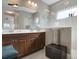 Bathroom with a double vanity, large mirror, glass shower and a ceiling fan at 7750 Ridgelake Cir, Bradenton, FL 34203