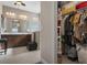 Bathroom with a double vanity, large mirror, glass shower and a ceiling fan at 7750 Ridgelake Cir, Bradenton, FL 34203