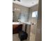 Bathroom with a double vanity, large mirror, glass shower and a ceiling fan at 7750 Ridgelake Cir, Bradenton, FL 34203