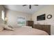 Inviting bedroom with neutral color scheme, ceiling fan, and warm accents of wooden furniture at 7750 Ridgelake Cir, Bradenton, FL 34203