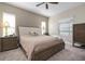 Serene bedroom with a king-size bed, neutral tones, soft lighting, and classic wooden furniture at 7750 Ridgelake Cir, Bradenton, FL 34203
